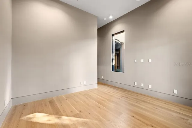 a bathroom with a sink and mirror with toilet