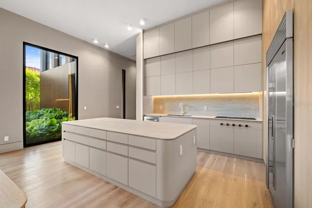 a bathroom with a granite countertop sink a toilet and shower