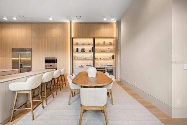 an empty room with wooden floor and entrance