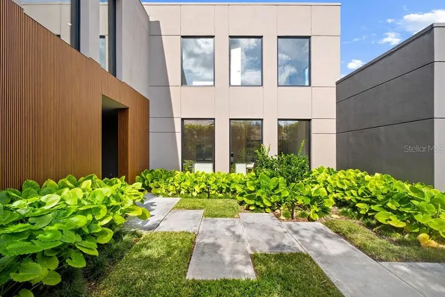 an aerial view of a houses with a swimming pool