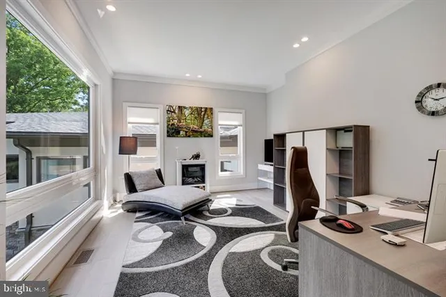 a kitchen with a sink a counter top space and living room view