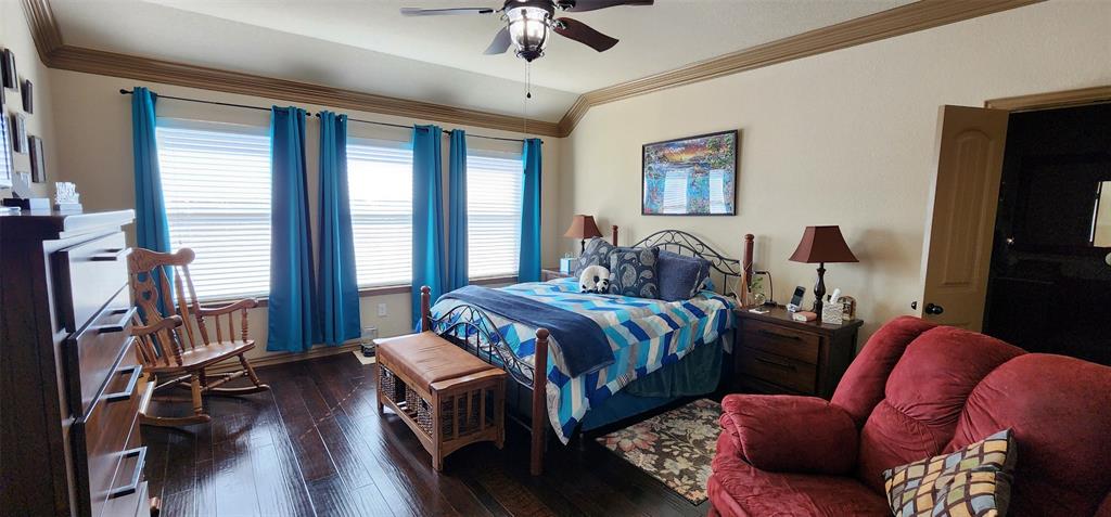 217 Heather Lane Decatur, TX 76234 - Photo 11 of 20 a bedroom with a bed couches and a flat tv screen