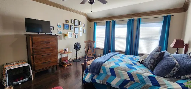 a bedroom with a bed furniture and a flat tv screen