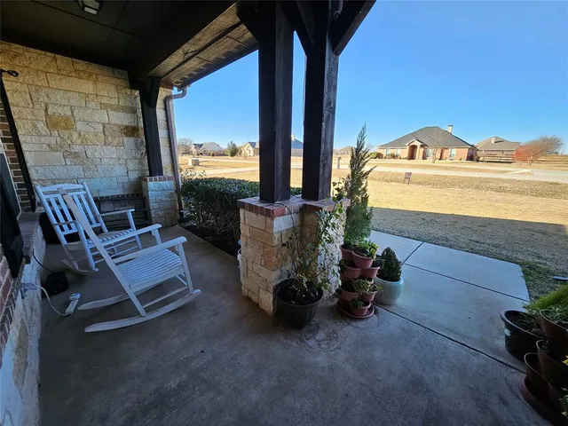 a view of living room with furniture and a floor to ceiling window