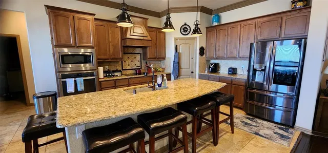 a dining table chair next to a window with kitchen view