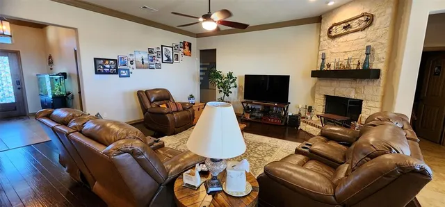 a living room with furniture fireplace and flat screen tv