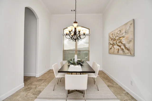 a view of a dining room with a table and chairs