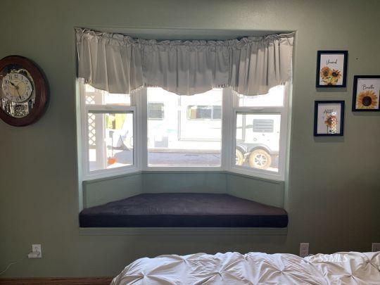 1320 Mayo Street Ridgecrest, CA 93555 - Photo 18 of 45 a bed sitting in a bedroom next to a window