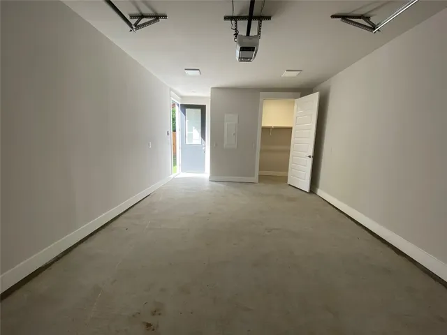 en empty room with windows and cabinet