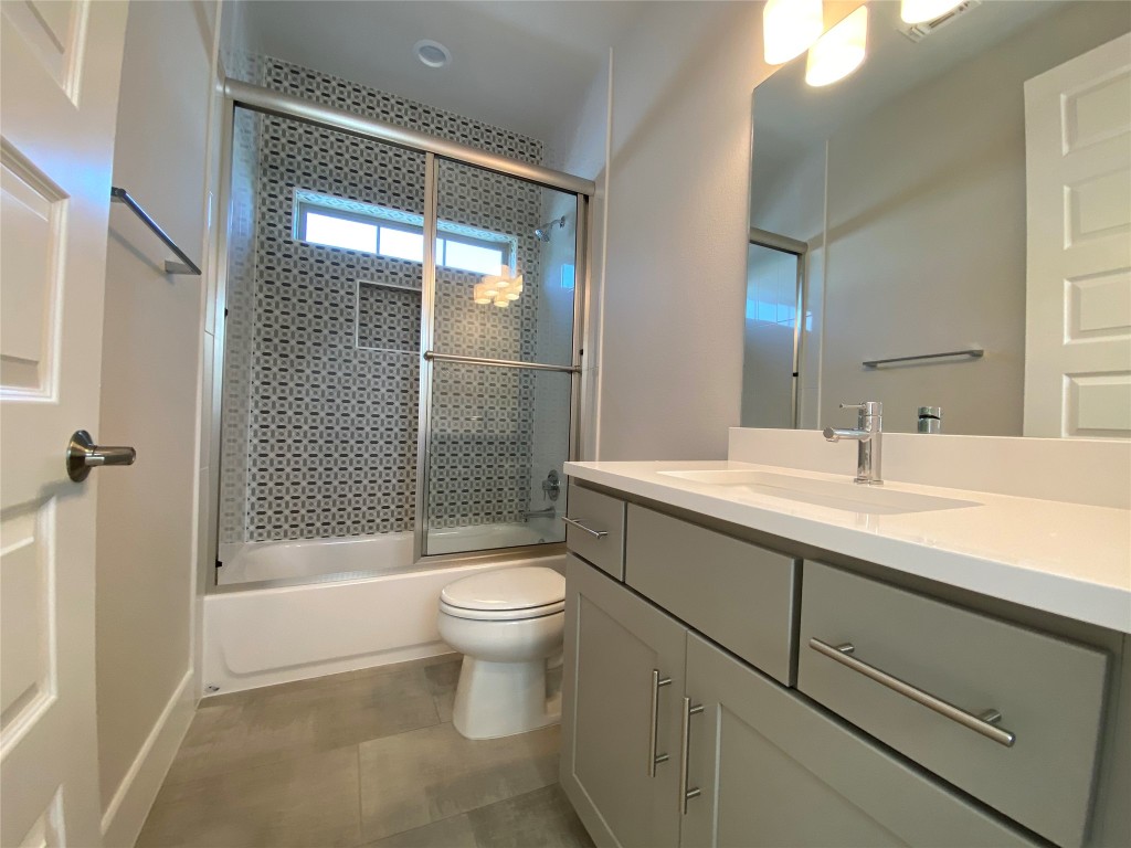 6920 Bethune Avenue, Unit 2 Austin, TX 78752 - Photo 20 of 20 Bathroom featuring vanity and shower / bath combination with glass door