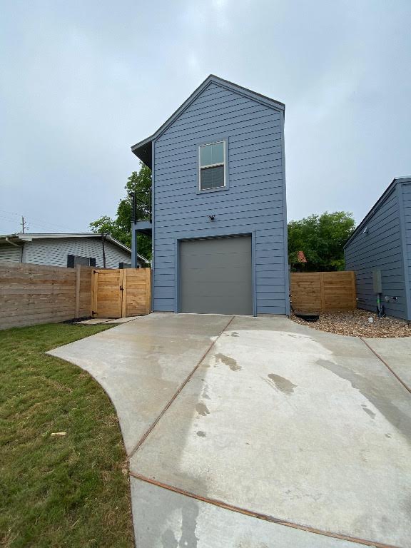 6920 Bethune Avenue, Unit 2 Austin, TX 78752 - Photo 2 of 20 View of side of property featuring concrete driveway, a gate, and a garage
