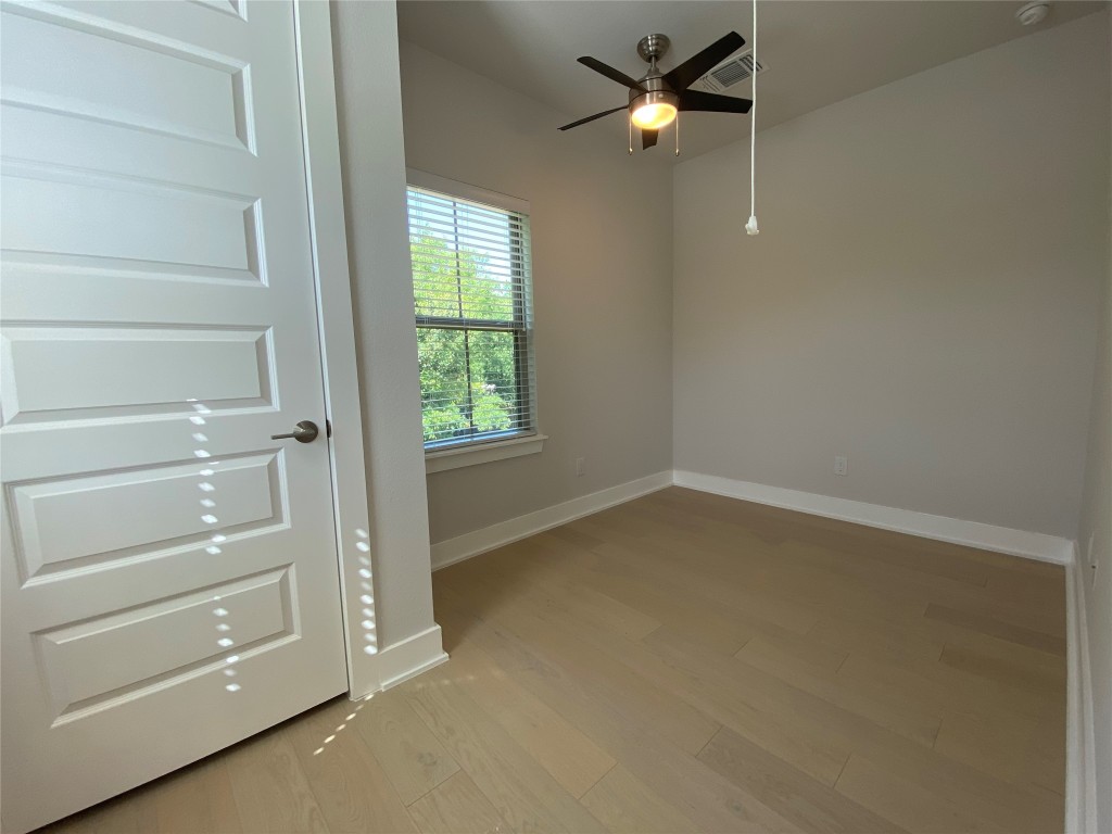 6920 Bethune Avenue, Unit 2 Austin, TX 78752 - Photo 6 of 20 Spare room with light wood-style floors and ceiling fan