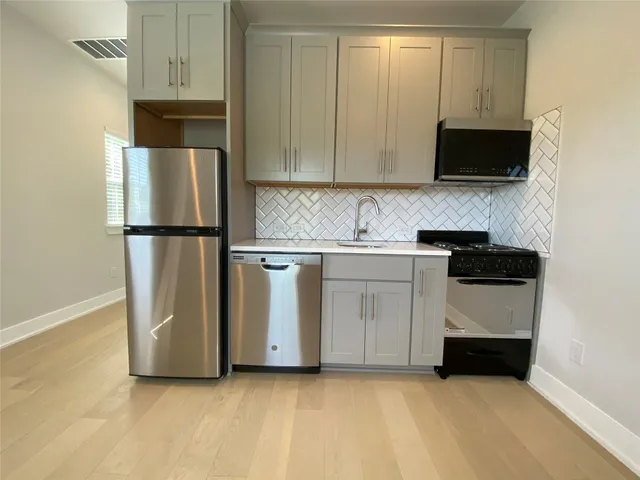 a kitchen with a sink and a refrigerator