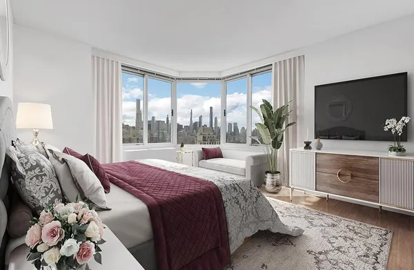 a bedroom with a bed and a flat screen tv