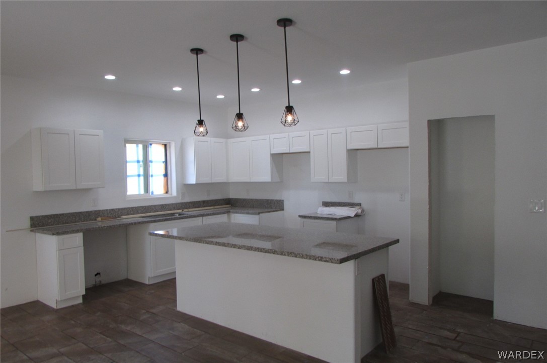 836 Ramar Road Bullhead City, AZ 86442 - Photo 5 of 10 a kitchen with kitchen island granite countertop a sink a counter space appliances and cabinets