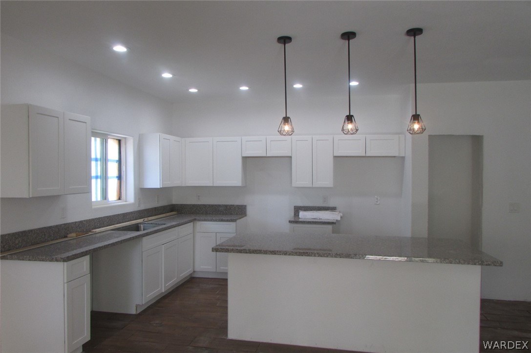 836 Ramar Road Bullhead City, AZ 86442 - Photo 6 of 10 a large kitchen with stainless steel appliances kitchen island a large island in the center