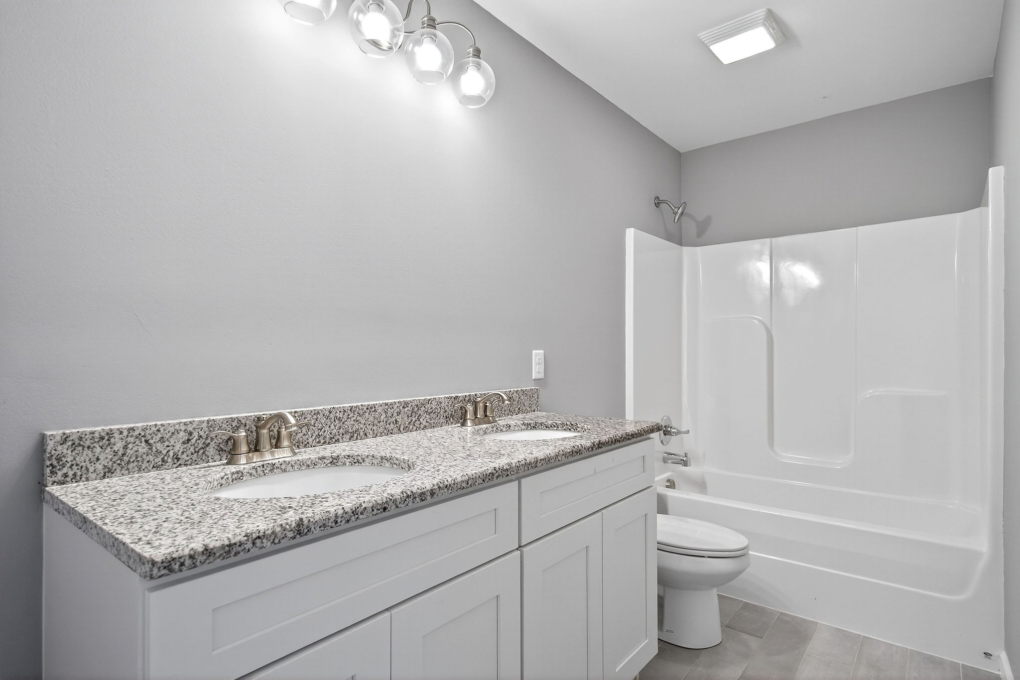409 Buffalo Valley Road Baxter, TN 38544 - Photo 15 of 29 a bathroom with a granite countertop sink a toilet and bathtub