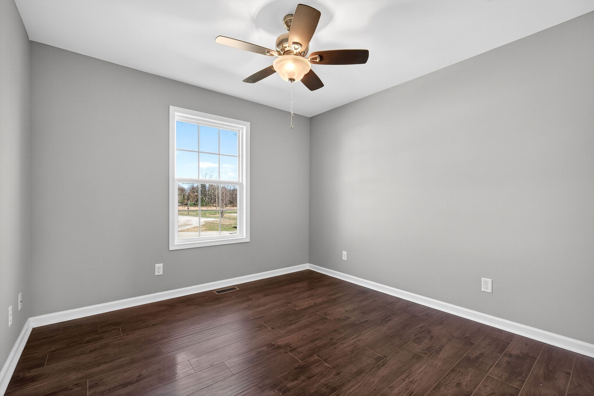 409 Buffalo Valley Road Baxter, TN 38544 - Photo 16 of 29 an empty room with wooden floor and windows