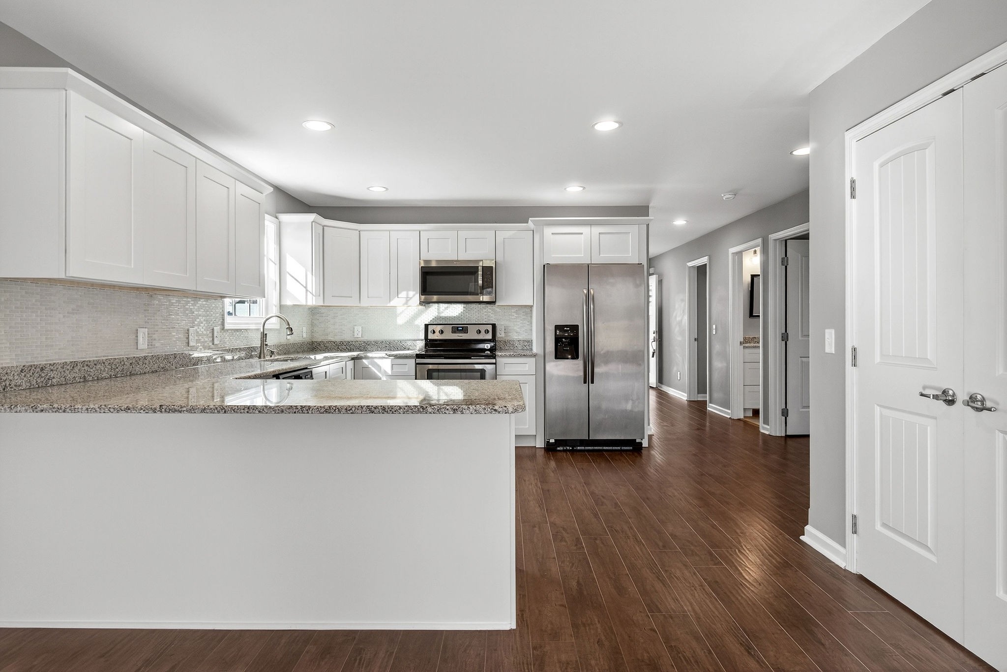 409 Buffalo Valley Road Baxter, TN 38544 - Photo 6 of 29 a kitchen with stainless steel appliances granite countertop a refrigerator a stove top oven a sink and dishwasher with wooden floor