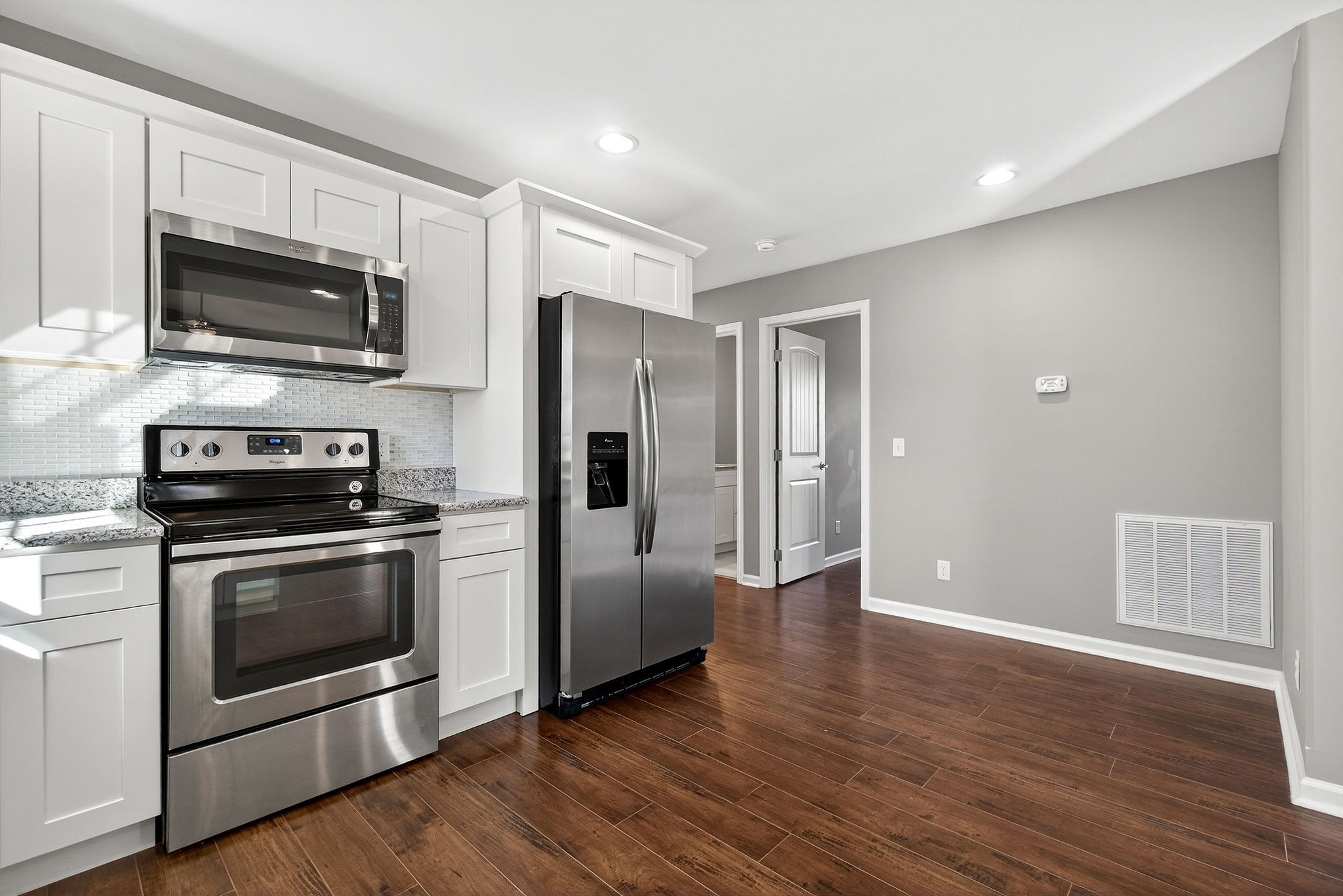409 Buffalo Valley Road Baxter, TN 38544 - Photo 7 of 29 a kitchen with stainless steel appliances granite countertop a stove a refrigerator and a microwave