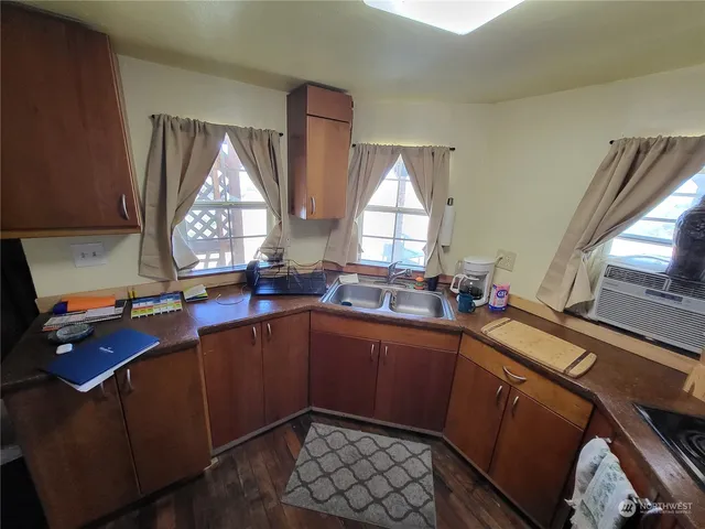a kitchen with sink window and cabinets