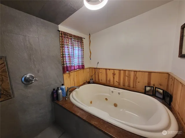 a bathroom with a bathtub and shower