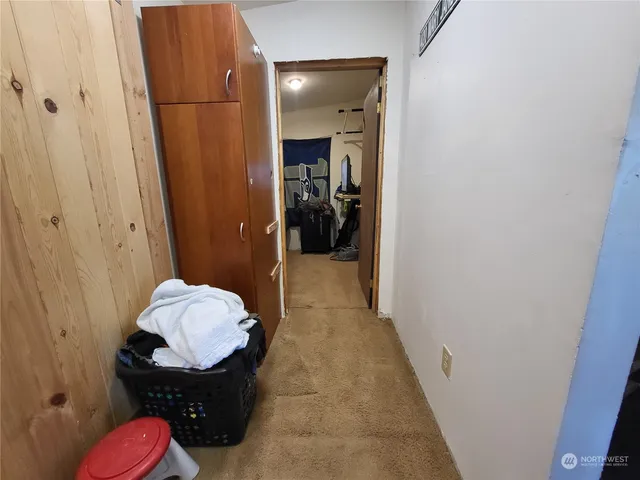 a hallway with kids room bathroom