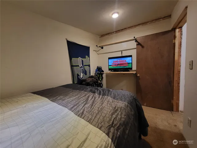 a bed room with a bed and a painting