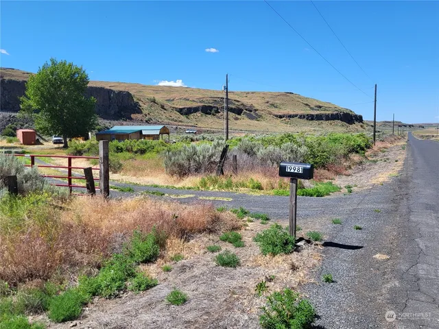 a backyard of a house with a yard and outdoor seating