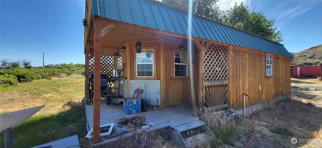 a view of a house with backyard and sitting area