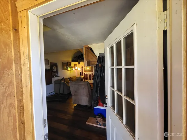 a view of living room with furniture and wooden floor