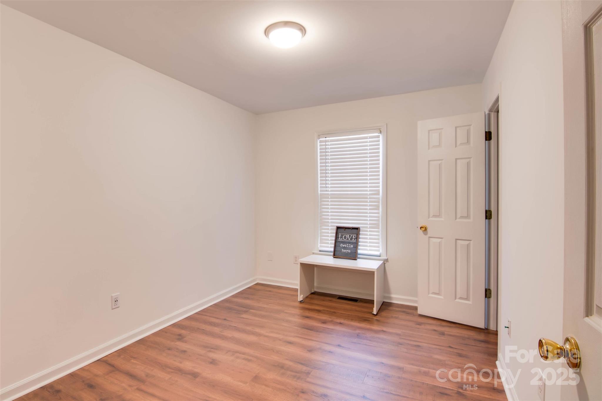806 East Ridge Street Kings Mountain, NC 28086 - Photo 14 of 38 a view of wooden floor and windows in a room