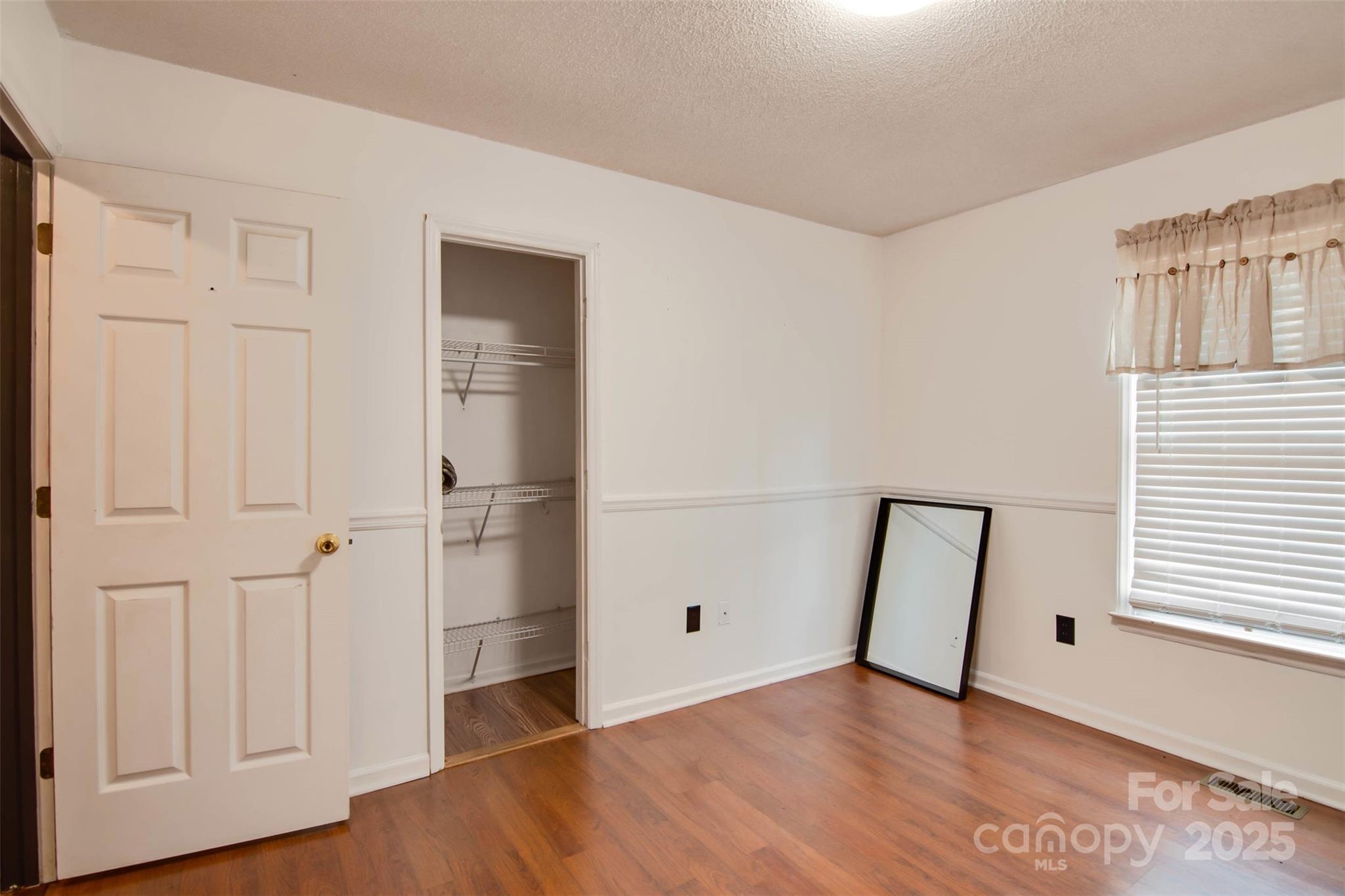806 East Ridge Street Kings Mountain, NC 28086 - Photo 15 of 38 a view of an empty room with wooden floor and closet