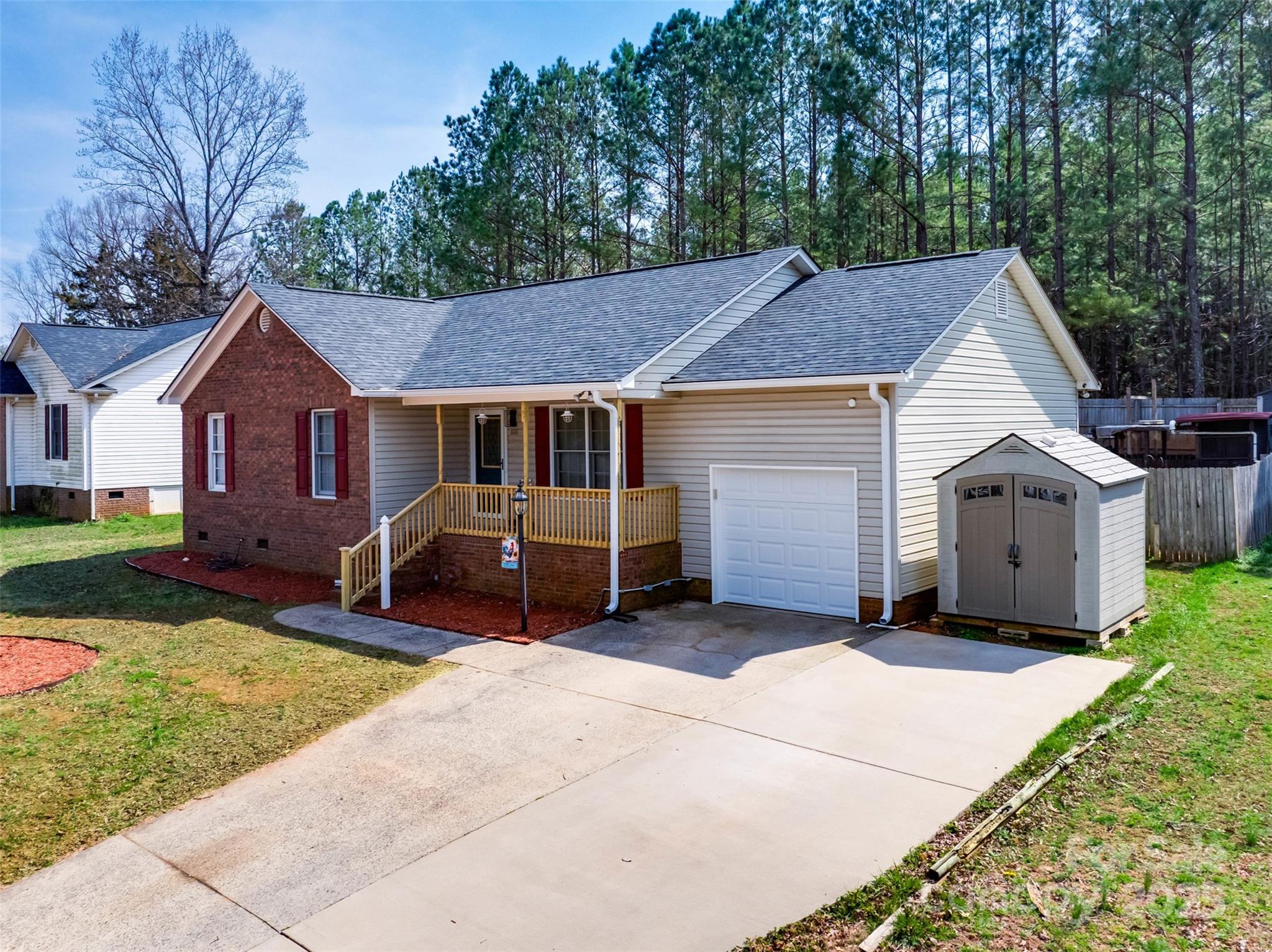 806 East Ridge Street Kings Mountain, NC 28086 - Photo 2 of 38 a front view of a house with a garden and trees