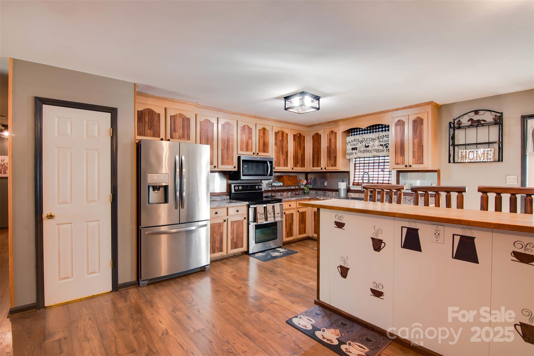 806 East Ridge Street Kings Mountain, NC 28086 - Photo 6 of 38 a kitchen with granite countertop a refrigerator and a stove top oven