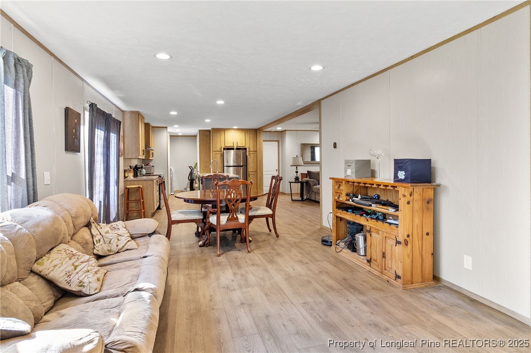 7096 Monarch Drive Linden, NC 28356 - Photo 13 of 31 a living room with furniture and a dining table with wooden floor
