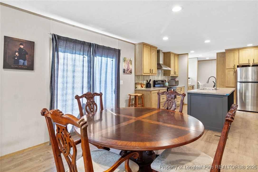 7096 Monarch Drive Linden, NC 28356 - Photo 14 of 31 a dining room with furniture a window and wooden floor
