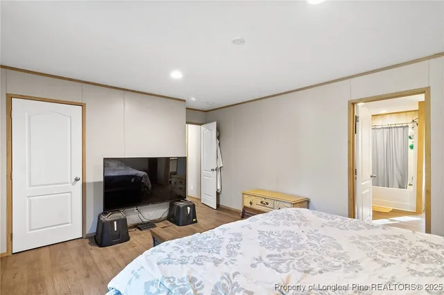 a bedroom with a bed and a flat screen tv