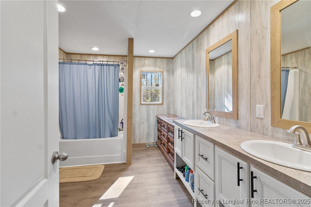 7096 Monarch Drive Linden, NC 28356 - Photo 18 of 31 a bathroom with a double vanity sink and a mirror
