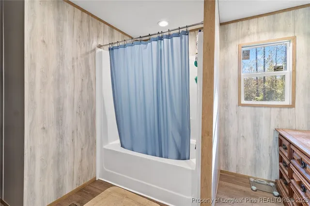 a view of a small space with wooden floor and a window