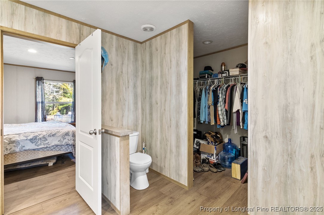 7096 Monarch Drive Linden, NC 28356 - Photo 21 of 31 a view of walk in closet with clothes and shoes