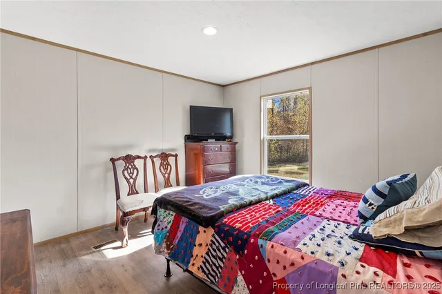 a bedroom with a bed furniture and a window