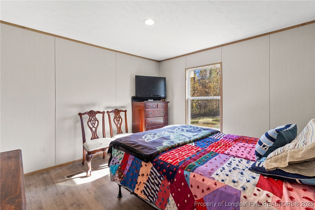 7096 Monarch Drive Linden, NC 28356 - Photo 27 of 31 a bedroom with a bed furniture and a window