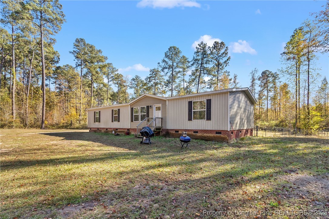 7096 Monarch Drive Linden, NC 28356 - Photo 30 of 31 a view of a house with a yard and tree s