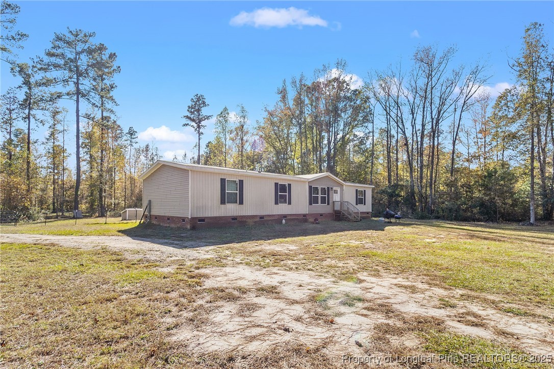 7096 Monarch Drive Linden, NC 28356 - Photo 3 of 31 a view of a house with a yard