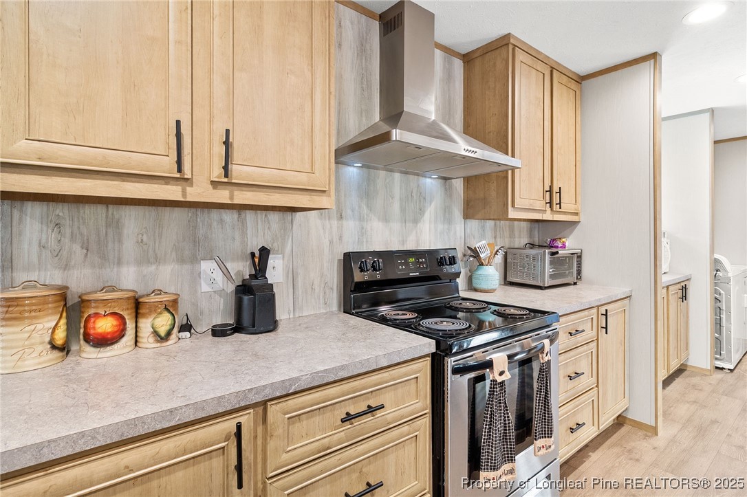 7096 Monarch Drive Linden, NC 28356 - Photo 8 of 31 a kitchen with stainless steel appliances granite countertop a sink a stove and a white wooden cabinets