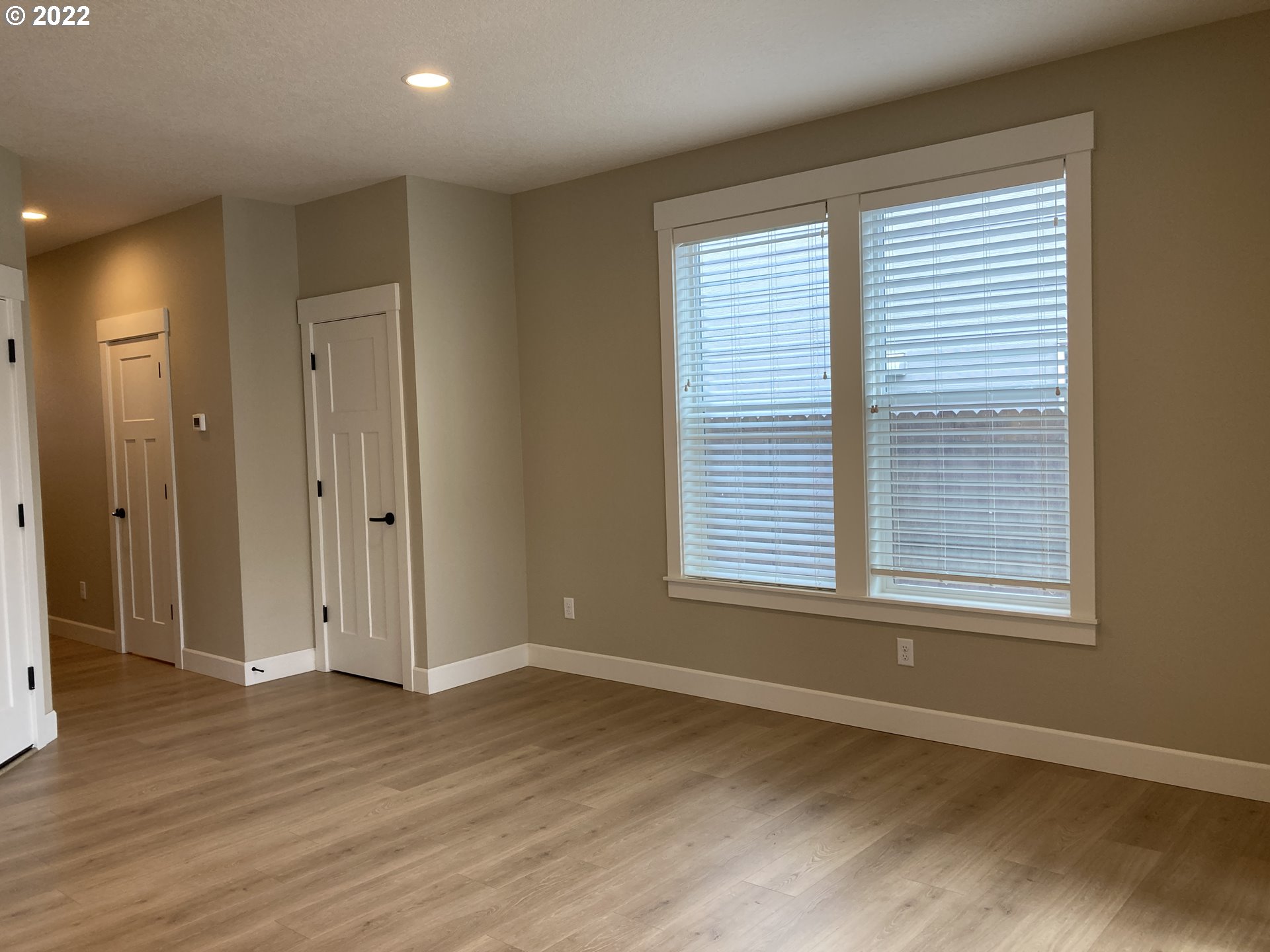 7415 South 13th Street Ridgefield, WA 98642 - Photo 9 of 28 an empty room with wooden floor and windows