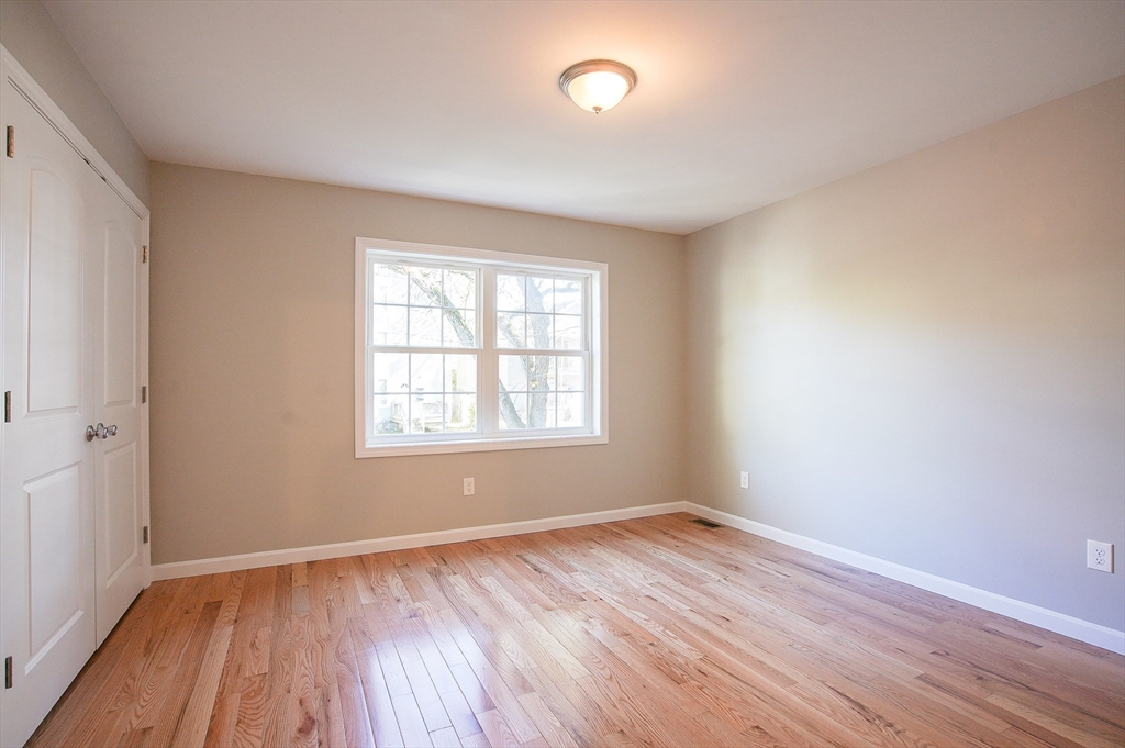 18-20 Healey Street, Unit 20 Springfield, MA 01151 - Photo 12 of 14 an empty room with wooden floor and windows