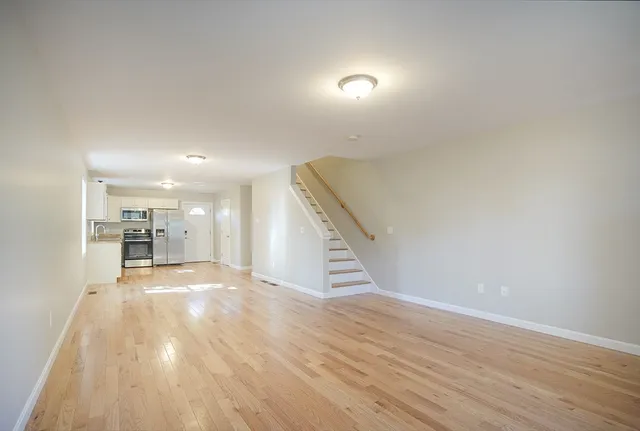 a view of a hallway with wooden floor