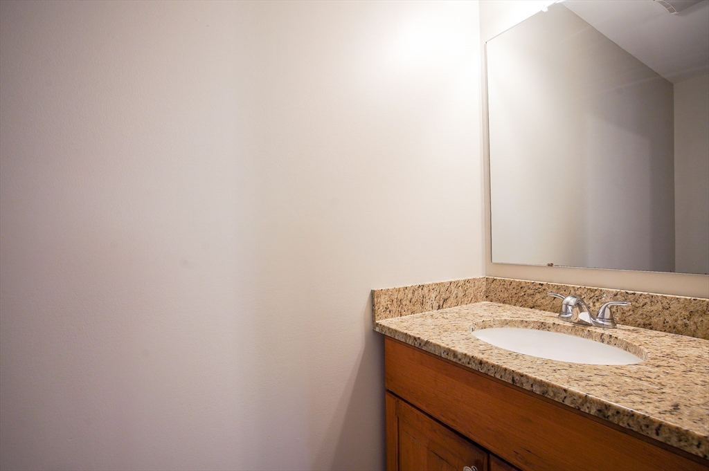 18-20 Healey Street, Unit 20 Springfield, MA 01151 - Photo 7 of 14 a bathroom with a granite countertop sink and a mirror